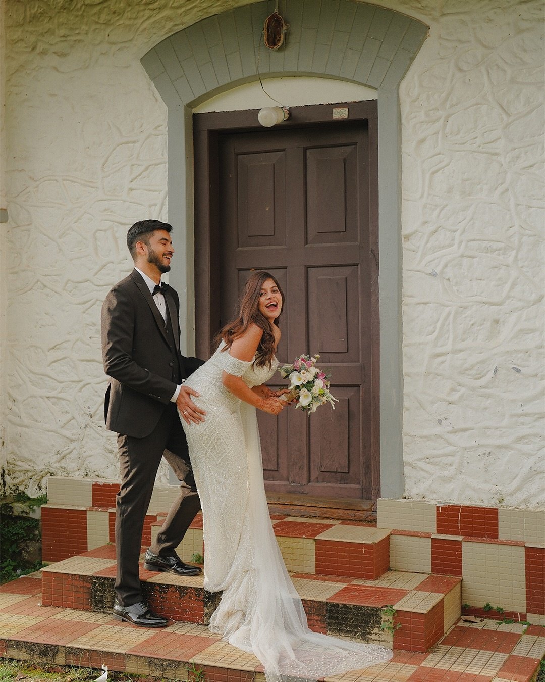 Groom lifting his bride during their portrait session
